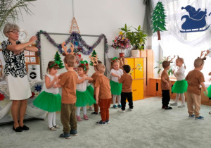 Dzieci ustawione w parach prezentują układ taneczny.
