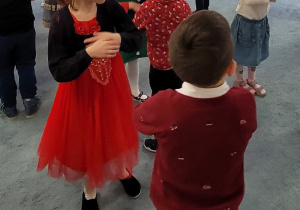 Dzieic w parach tańczą do świątecznych utworów.