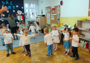 Dzieci przy dźwiękach muzyki naśladują ruchy wodzireja.