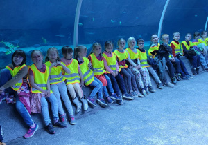 Dzieci stoją w podwodnym tunelu.
