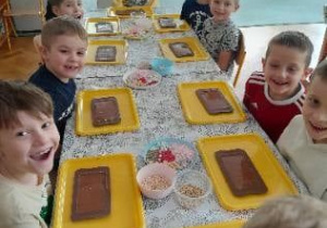 Dzieci dekorują swoje czekolady.