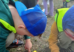 Zmysł wzroku dzieci oglądają las pod lupą.