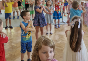 Dzieci tańczą przy hiszpańskiej piosence "Macarena".