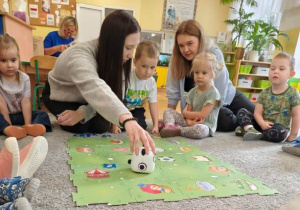 Prowadząca umieszcza robota na macie do kodowania.
