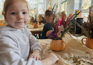 Dziewczynka pozuje ze swoim bukietem.