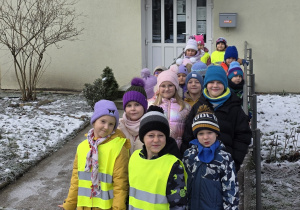 Dzieci stoją przed wejściem do Biblioteki Miejskiej TRAF.