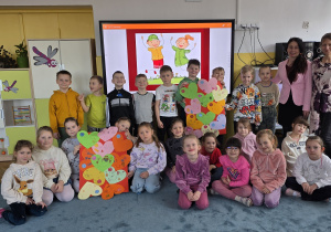 Pamiątkowe zdjęcie grupowe z plakatami wykonanymi na warsztatach.