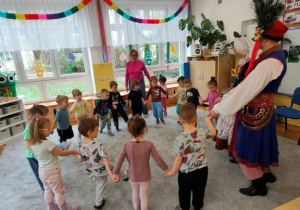 Dzieci wspólnie z tancerzami ćwiczą wybrany element tańca.