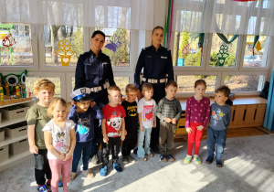 Dzieci pozują do zdjęcia z funkcjonariuszki policji.