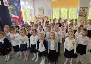 Dzieci śpiewają hymn narodowy "Mazurek Dąbrowskiego".