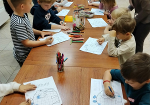Dzieci kolorują słonie według kodu.