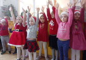 Dzieci unoszą ręce do góry podczas zabawy.